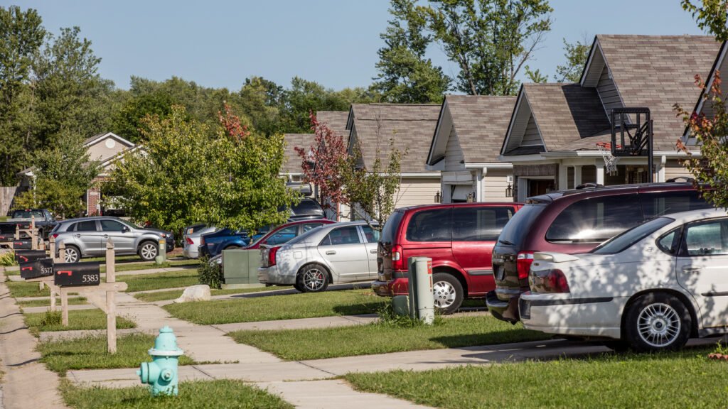 A picture from 2016 of different types of cars on people's streets in a city street